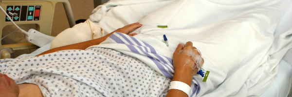 Victim of medical malpractice lying in a hospital bed